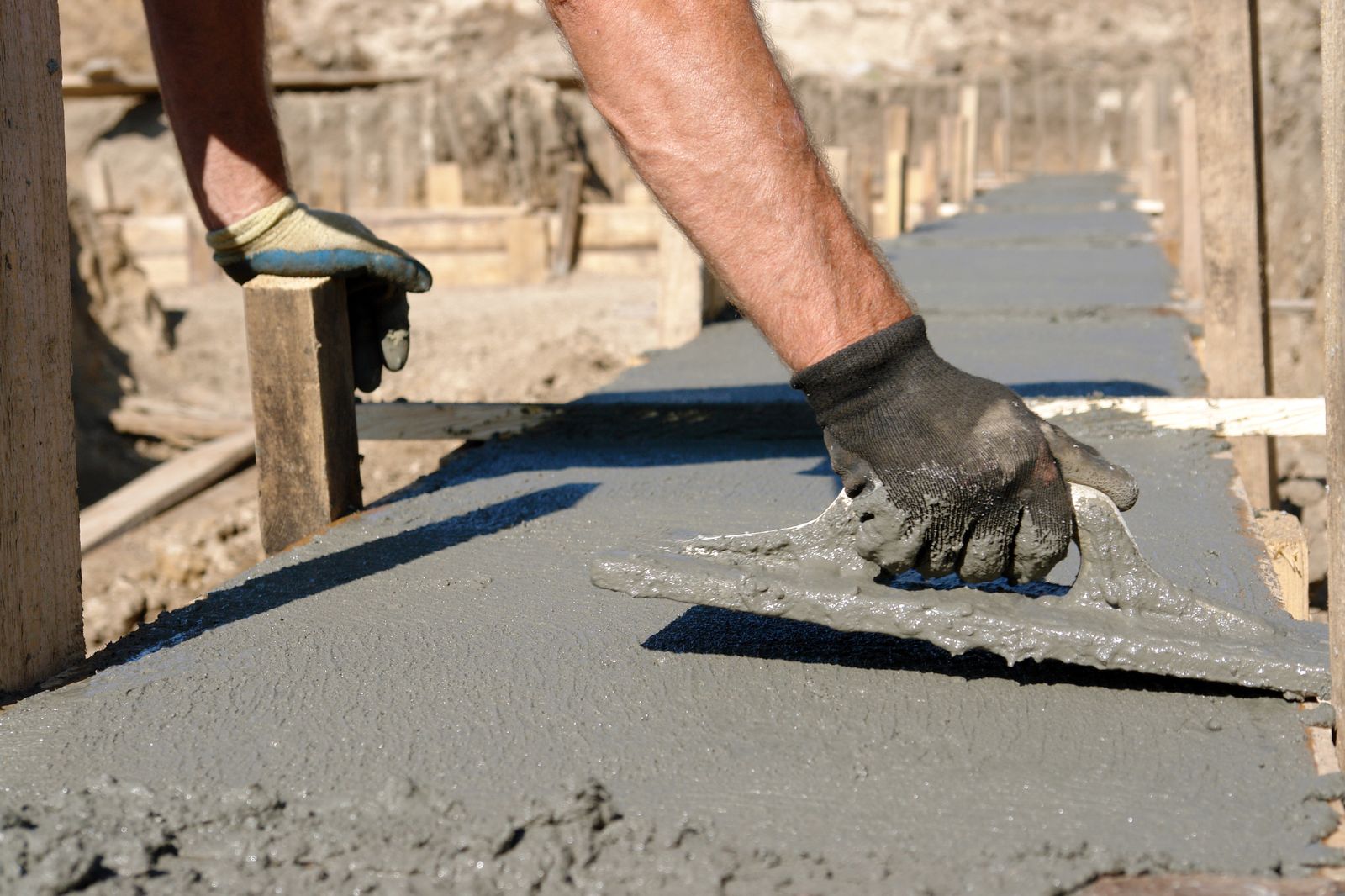 Crew bull-floating a fresh concrete driveway pour in Berwyn